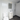 Bathroom with white toilet, sink, and mirror on a tiled floor.