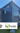 Modular container home on a grassy area with 'AgQuip' and 'AgTrader' logos.