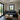 Modern living room with a gray sofa, wooden coffee table, and TV stand in a container home