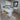 U-shaped kitchen with white benches, breakfast bar, dishwasher insert, sink and stove